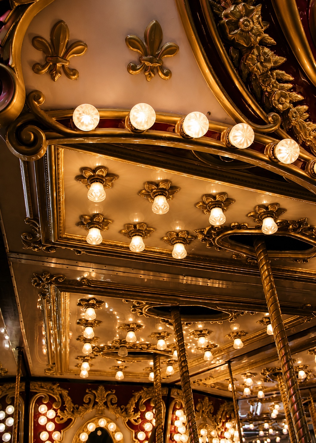 Warm theatre lights reflected in ornate mirrors